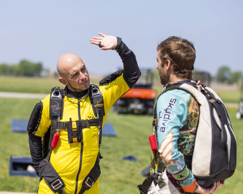 A solo skydiving student practicing the dive flow at Skydive Chicago