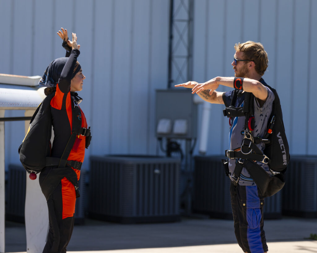 Skydive Instructor preparing to jump with a solo skydiving student in Skydive Chicago's AFP Program