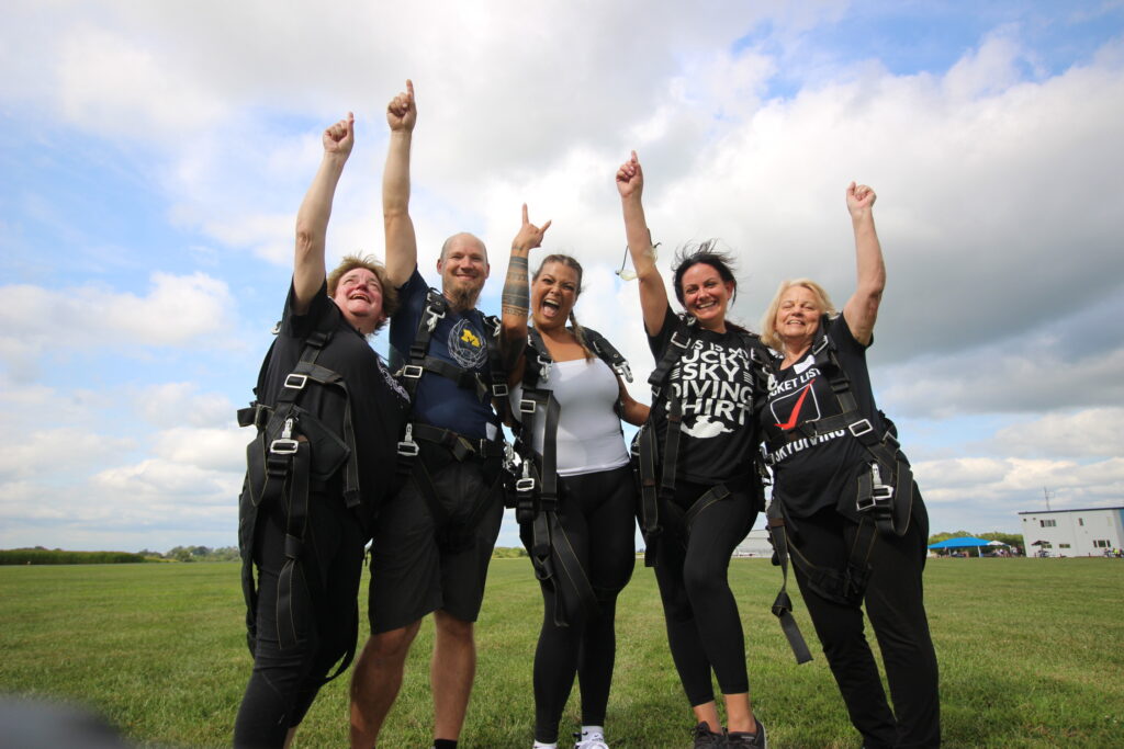 tandem skydivers celebrating after their first jump at Skydive Chicago