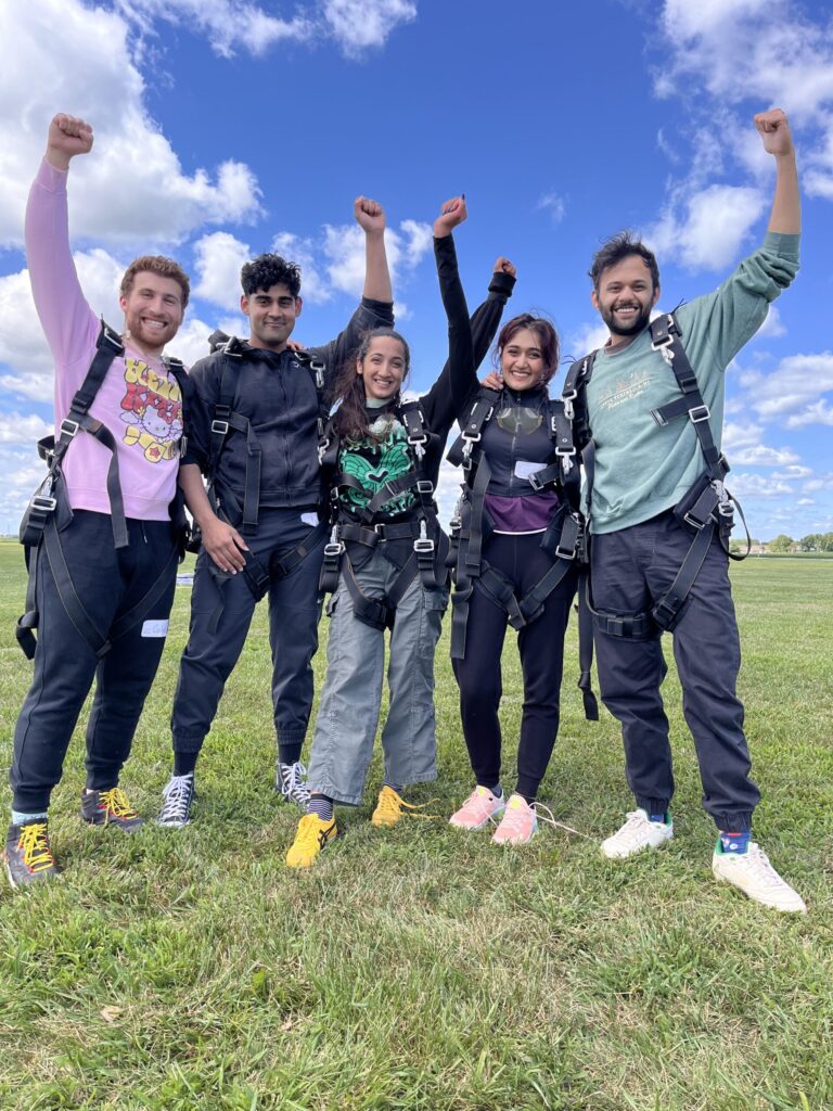 first time tandem skydiving group celebrating after their jump at Skydive Chicago