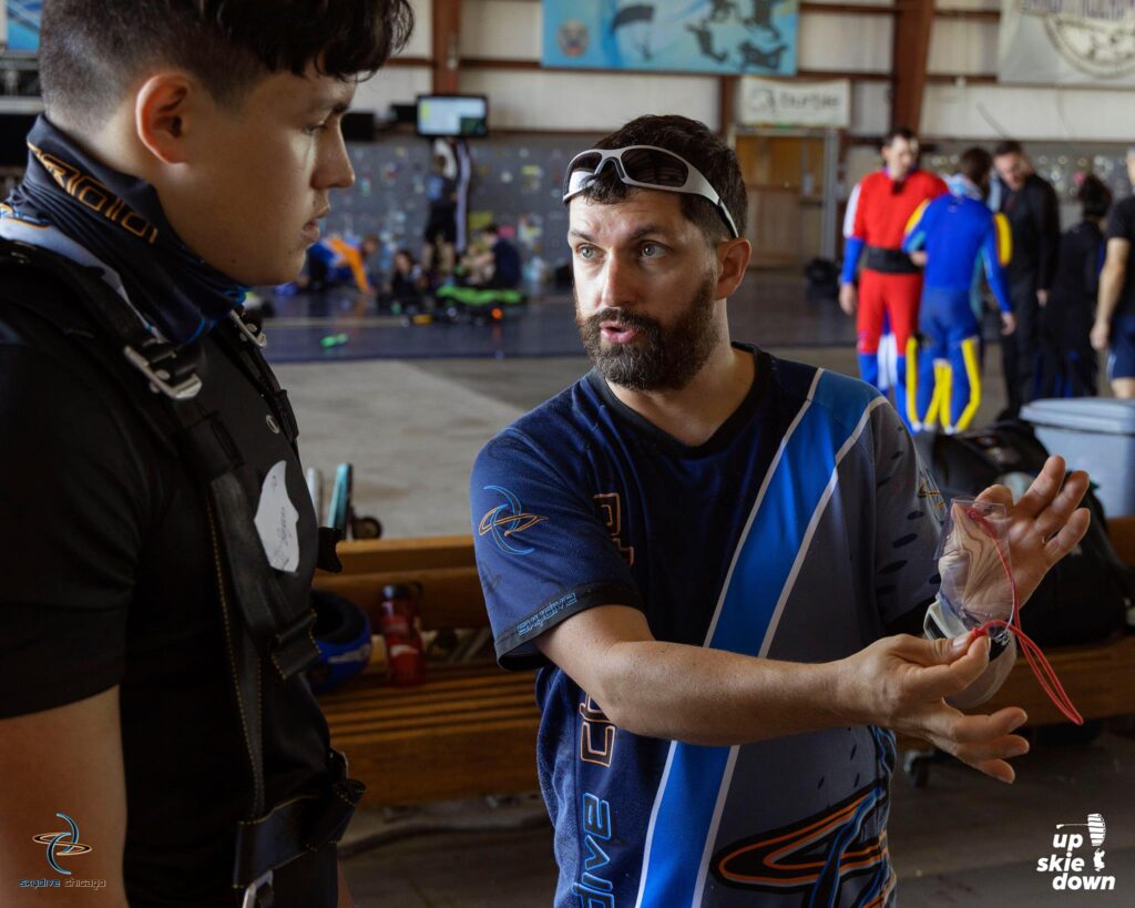 Skydive instructor, Baxter working with a solo skydive student