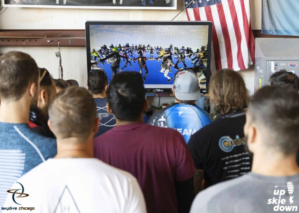 Vertical Sequential World Record participants watch their inside views at Skydive Chicago